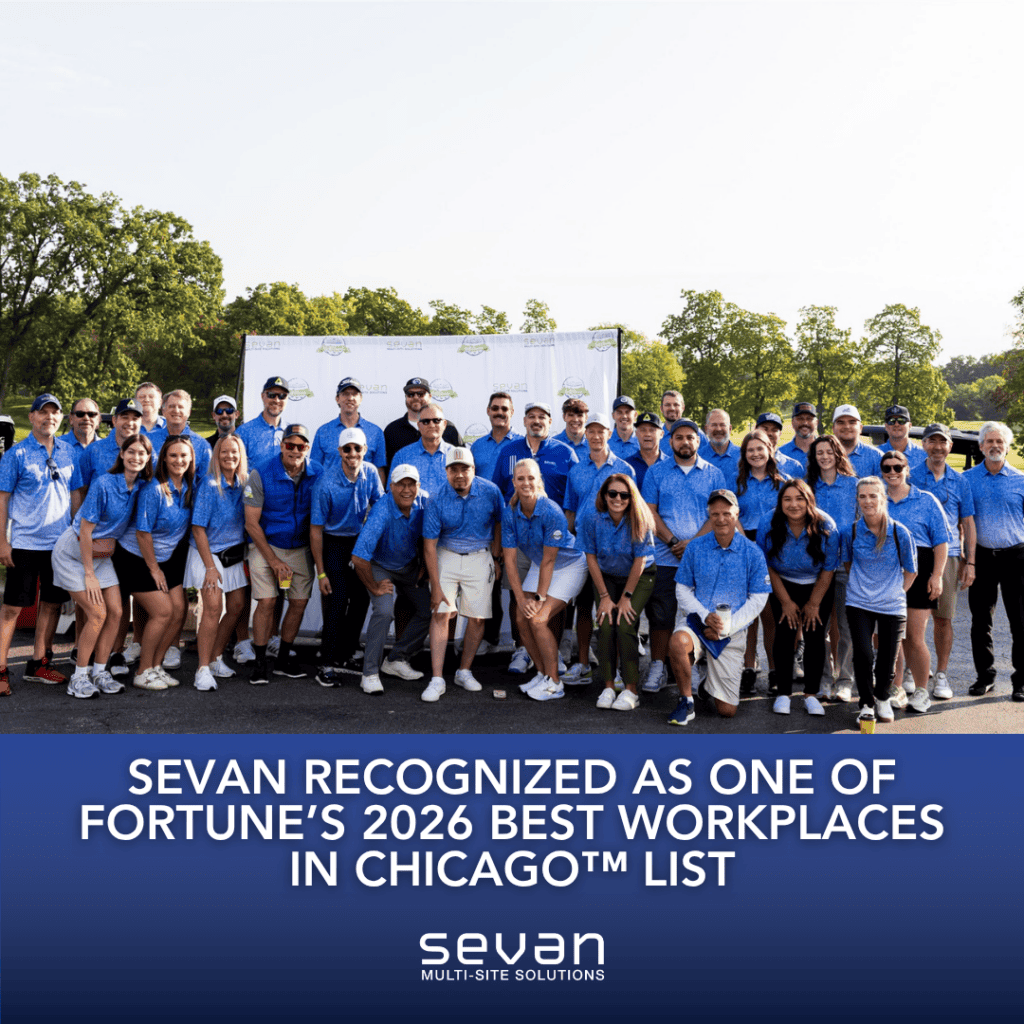 A large group of people in matching blue shirts pose outdoors at an event; text announces Sevan's recognition as a top Chicago workplace for 2026 by Fortune.