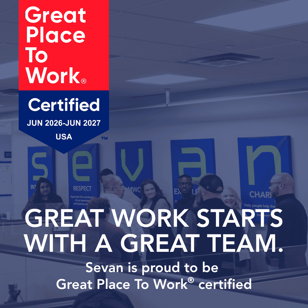 A group of people stand in an office under company value signs. Text highlights Sevan's Great Place To Work certification for June 2026–June 2027 in the USA.