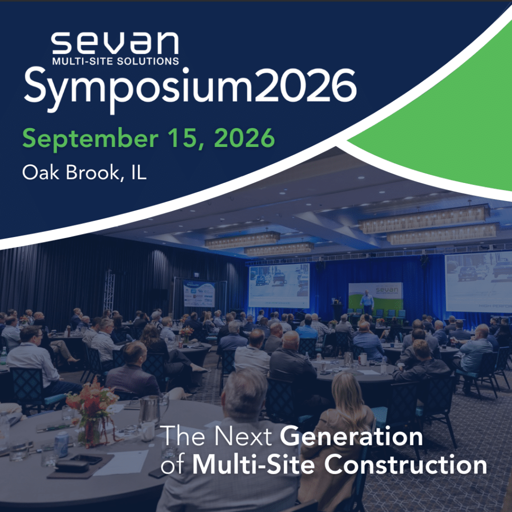 Sevan Multi-Site Solutions Symposium to Focus on Next Generation of Multi-Site Construction 1 People seated at round tables in a conference room watch a presentation with screens. Symposium2026 event details and theme text are overlaid at the top.