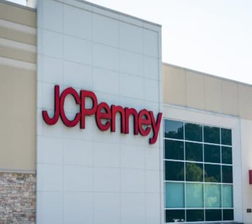The exterior of a JCPenney store with large red letters spelling "JCPenney" on a white and beige building facade appears to be undergoing remodel construction.